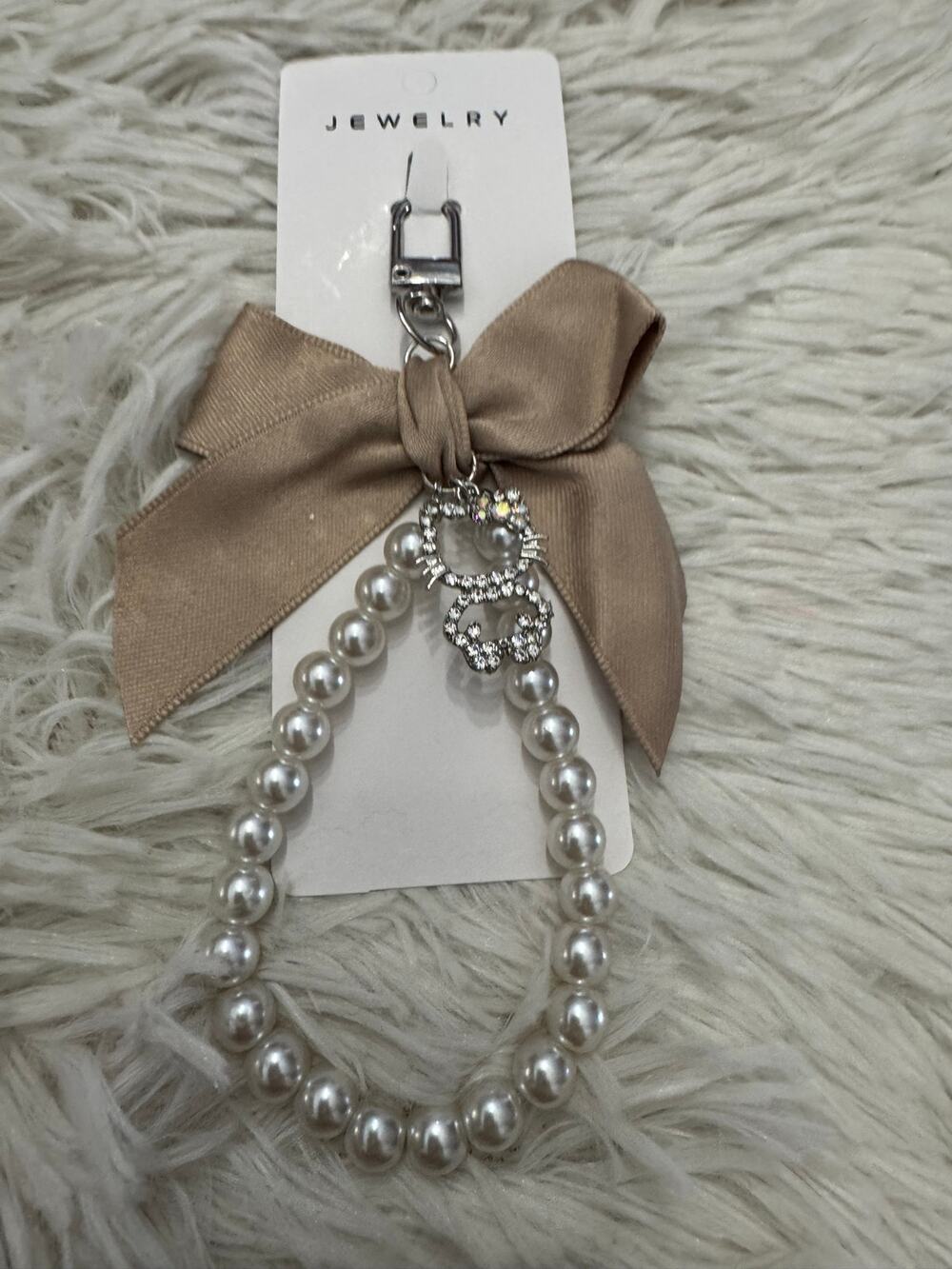 Hello Kitty pearl with silver Hello Kitty rhinestones charm and a bow